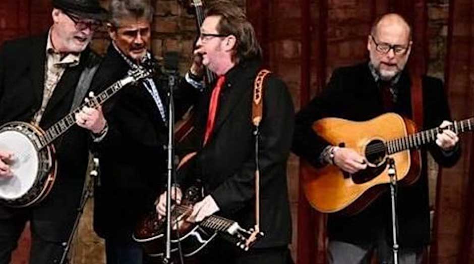 4 mature male musiscians on stage